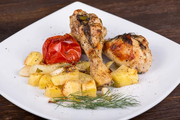 Grilled chicken legs with potato and vegetables