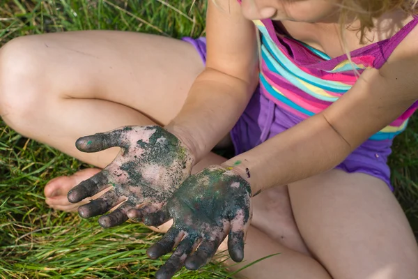 Little girl with painted hands