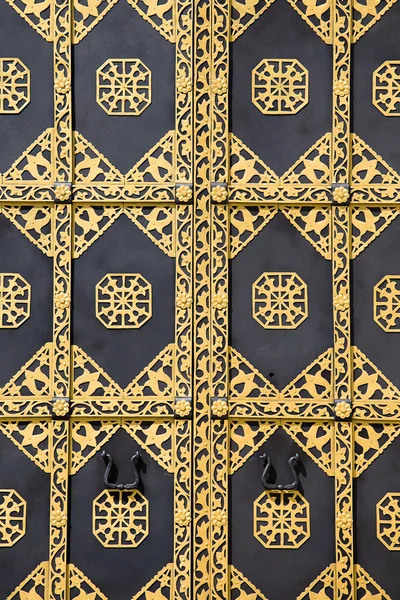 Ornamented gold door. Golden decoration of the door to Cathedral of the Dormition in Kiev Pechersk Lavra - famous monastery inscribed on UNESCO world heritage list. Ukrainian landmark.