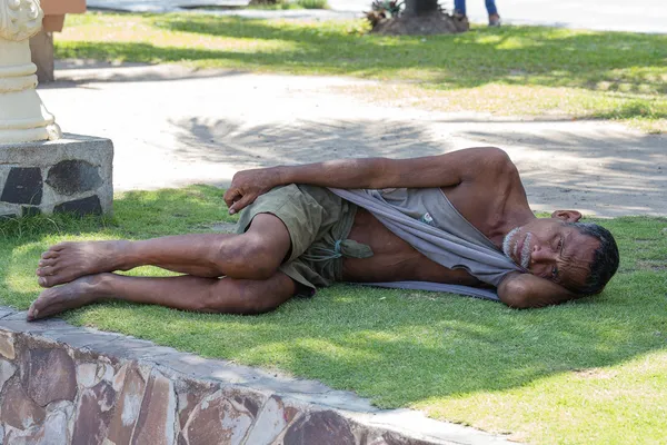 Beggar man sleeping on the street, Philippines