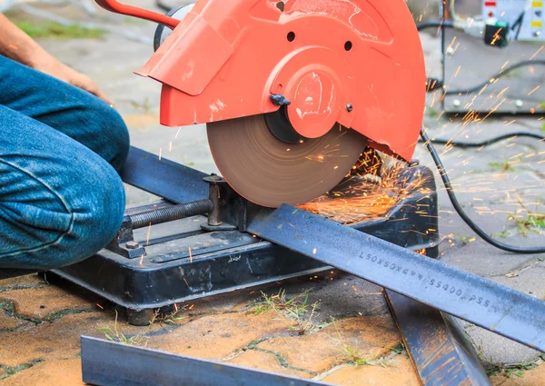 Worker cutting metal with grinder