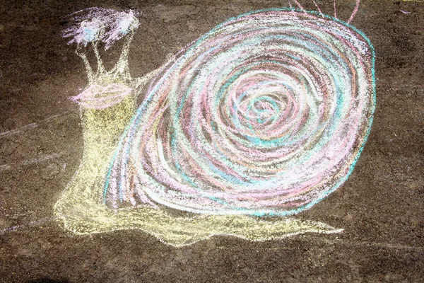 Children drew a snail on asphalt
