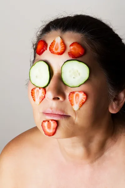 Mature woman making cosmetic mask