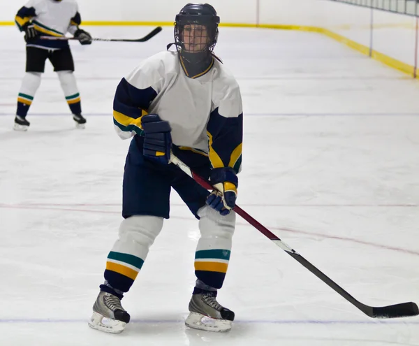 Female ice hockey player in game action