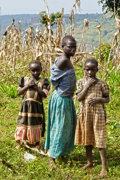 Three african girls in ragged clothes