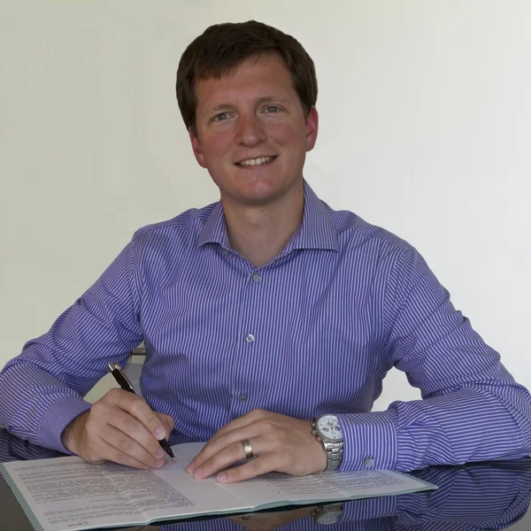 Signing document with purple shirt