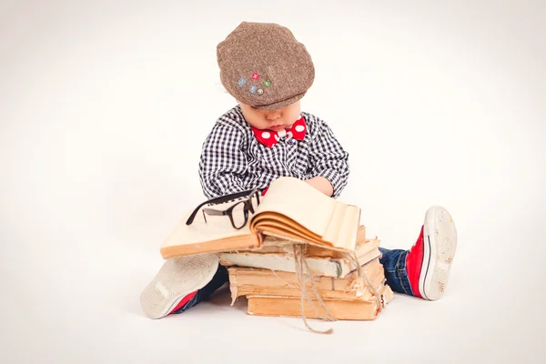 Little boy reading a big book.