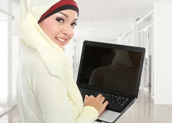 Muslim woman in head scarf studying using laptop — Stock Photo #23556931