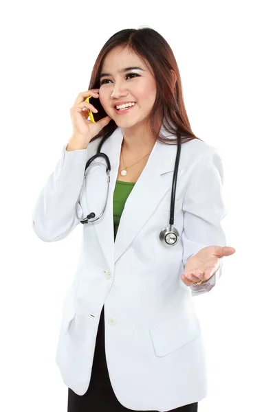 Attractive female doctor in lab coat with stethoscope talking wi