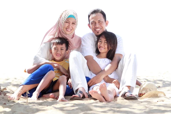 Portrait of happy muslim family in the beach