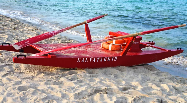 Red rescue boat on the beach