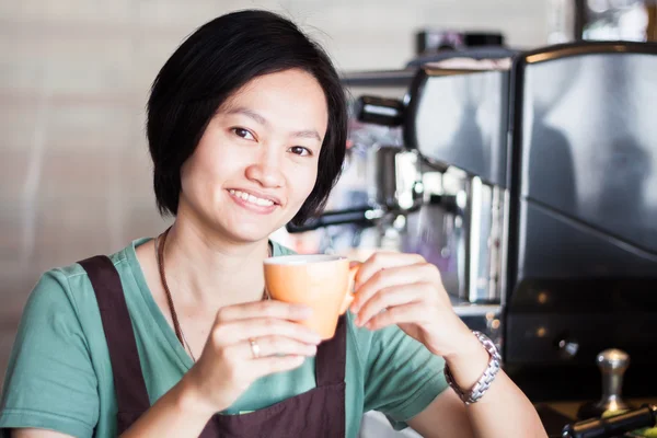 Asian barista enjoy her coffee