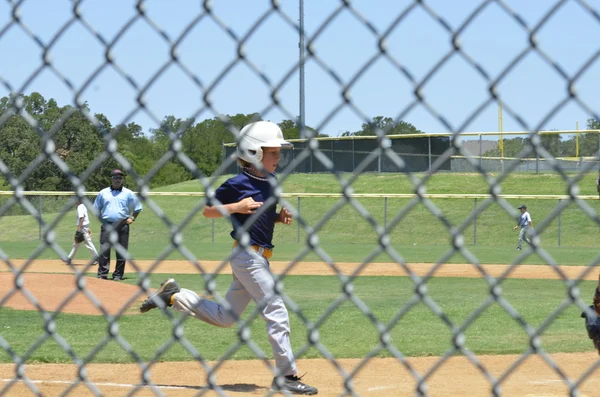 Little Leager running to home plate