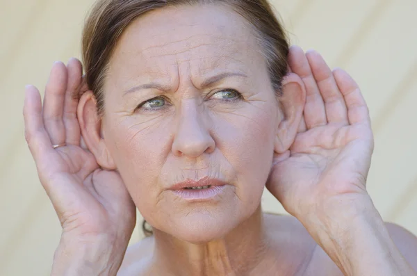 Woman hand to ear listening isolated outdoor