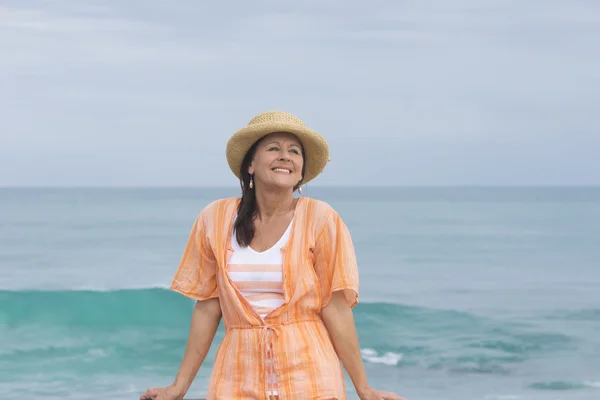 Happy friendly mature woman beach ocean