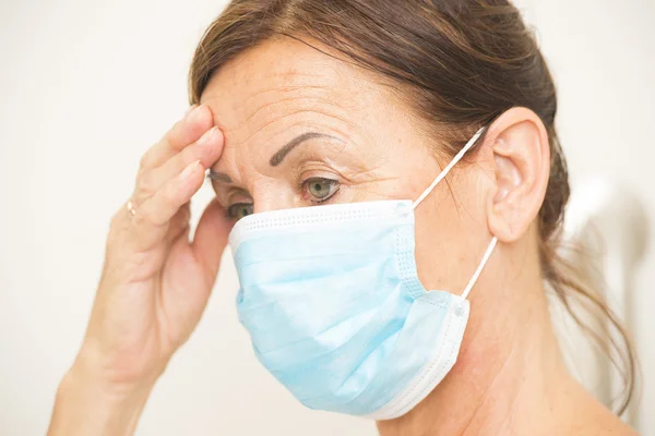 Exhausted medical nurse with mask over face