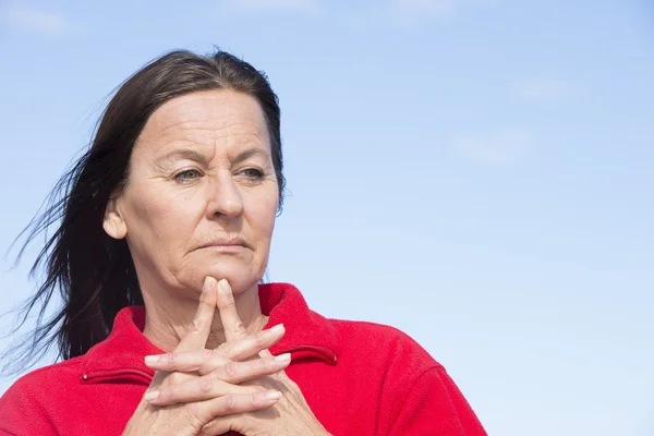 Worried middle aged woman wrinkled forehead