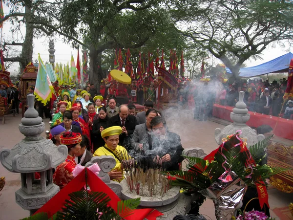 Group of people in traditional costume give gifts to the holy