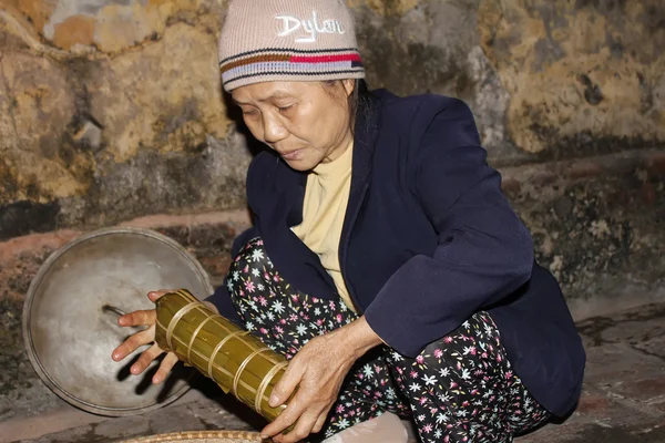 Asian woman packing rice cake