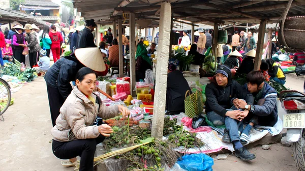 Asian woman selling incense in the market