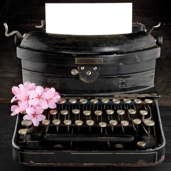 Old antique black vintage typewriter with flowers
