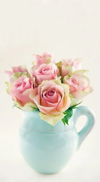 Pink roses in a blue vase