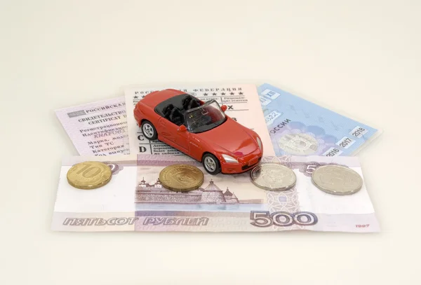 Red toy car, money and documents