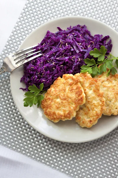 Chicken fritters and stewed red cabbage with caraway seeds