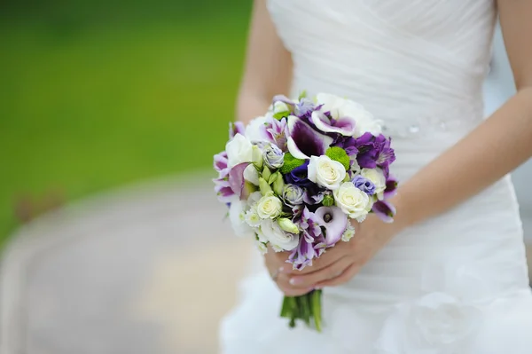 Wedding bouquet of purple and white flowers