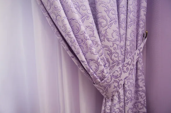 Balcony window with purple curtains