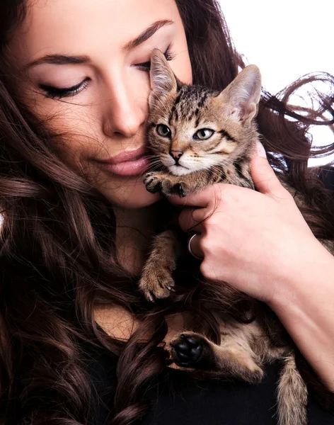 Young woman holding kitten