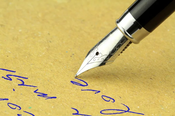 Fountain pen writing on the paper,