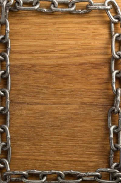 Metal chain on wood