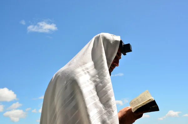 Jewish man pray to God under the open blue sky