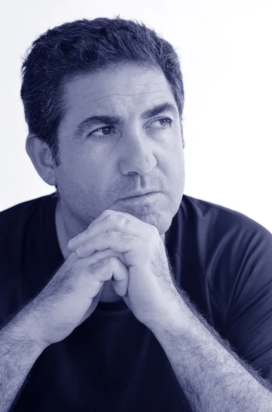 Mature man thinking with hands on chin looking away