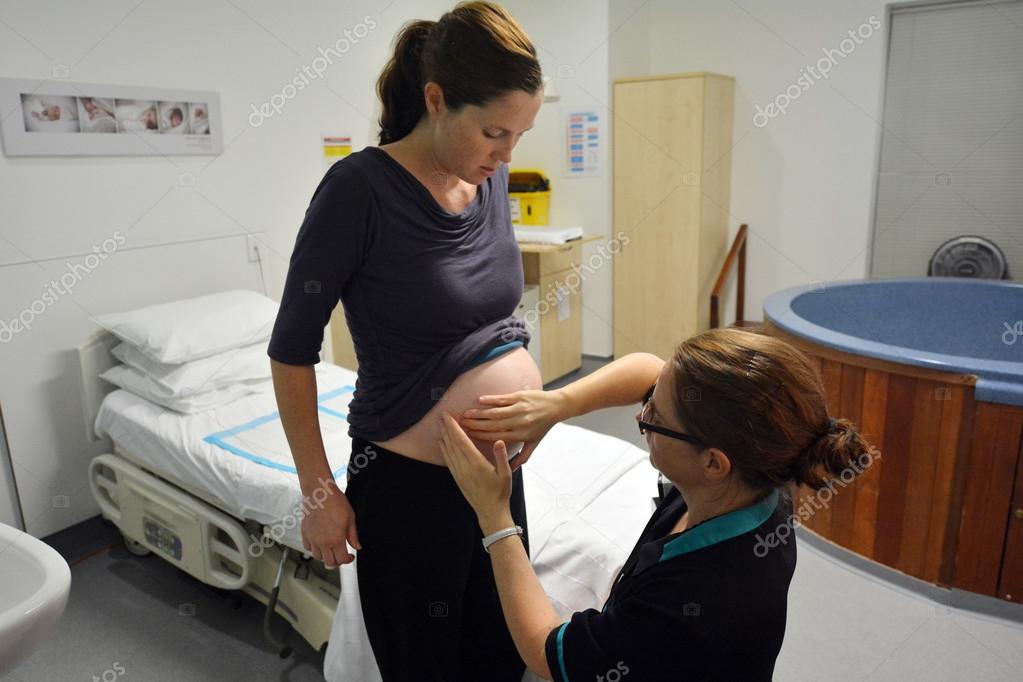 Pregnant woman having contraction Stock Editorial Photo © lucidwaters