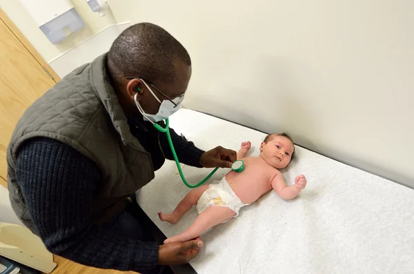 Doctor checks newborn baby