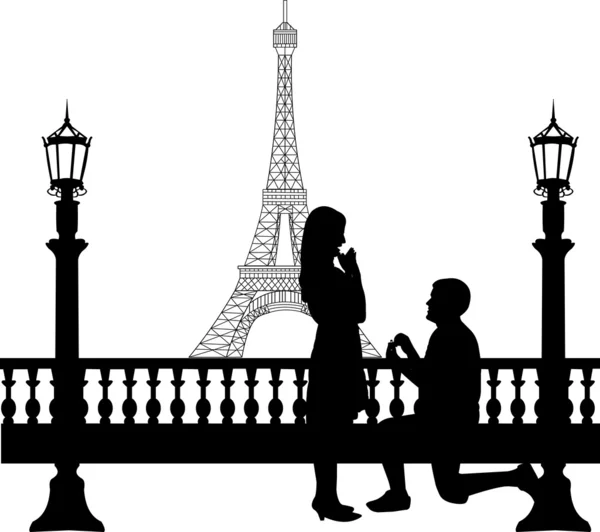 Romantic proposal in Paris in front of Eiffel tower on Valentine\'s day of a man proposing to a woman while standing on one knee silhouettes