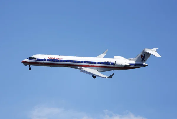 American Eagle Bombardier CRJ-700 plane in New York sky before landing in La Guardia Airport