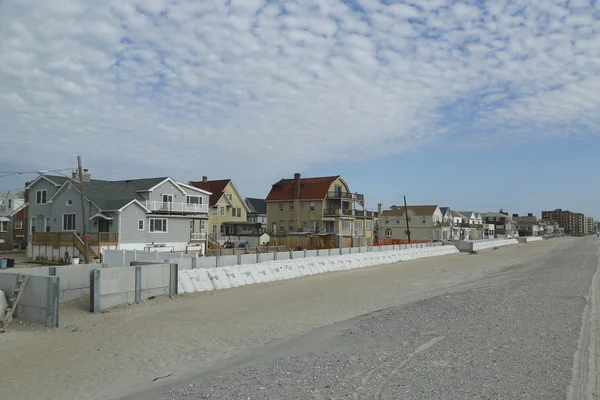 Protective barrier build to prevent damage in devastated residential area one year after Hurricane Sandy