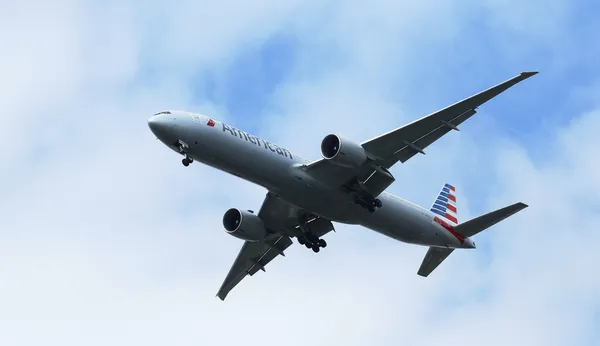 American Airlines Boeing 777 in New York sky before landing at JFK Airport