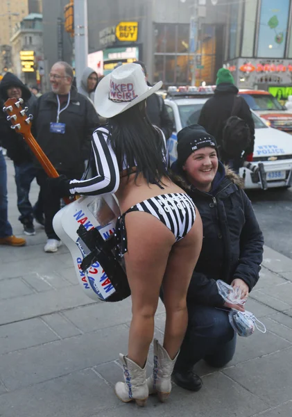 Alex, the Naked Cowgirl, entertains the crowd in Times Square during Super Bowl XLVIII week in Manhattan