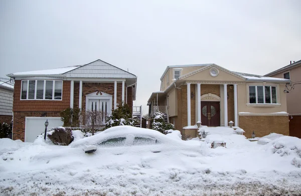Car and house under snow after massive winter storms strikes Northeast