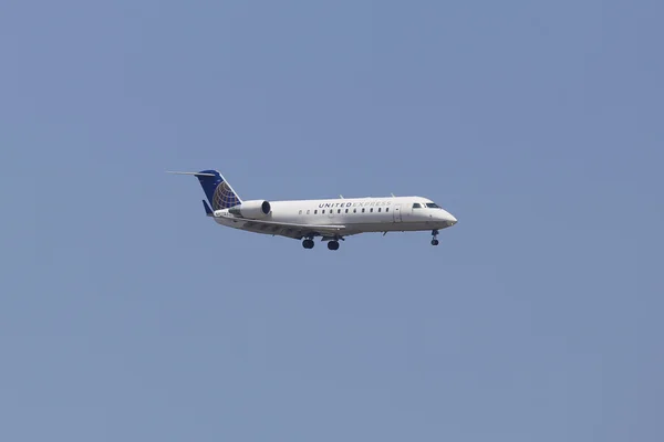 United Express Canadair CRJ-100 jet in New York sky before landing at JFK Airport