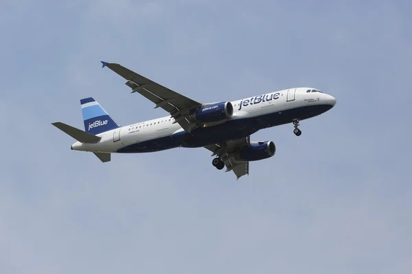 JetBlue Airbus A320 in New York sky before landing at JFK Airport