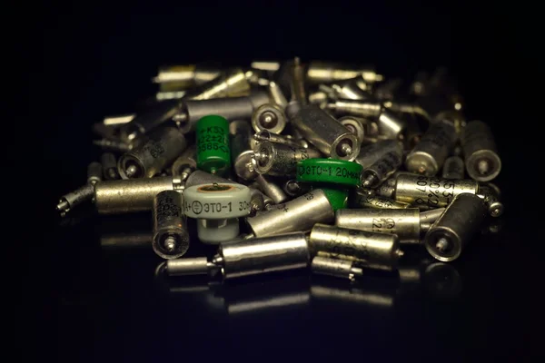 Tantalum capacitors (scrap) on a black background