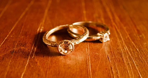 Background with vintage wedding rings that laying on an old wooden table