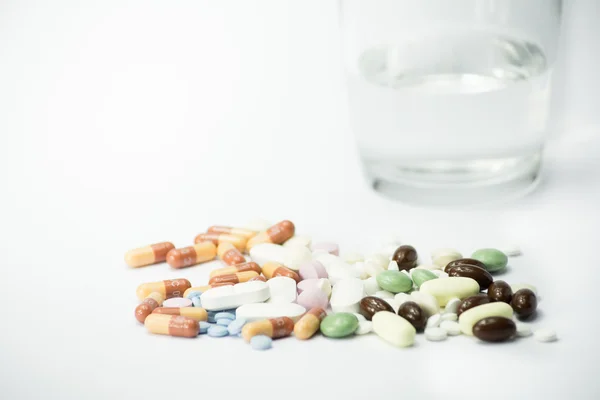 Pills near a cup of water