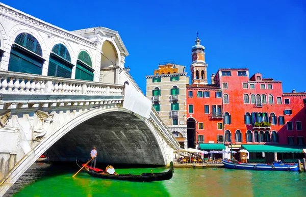 Rialto bridge with traditional Gondola under the bridge in Venice, Italy
