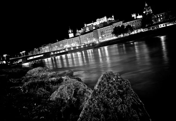 Artistic view of the city of Salzburg with river Salzach at night in black and white, Salzburger Land, Austria